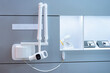 Dental equipment x-ray in clinic. X-ray machine in dental office. Intraoral high-frequency X-ray machine is mounted on wall. Equipment for creating picture of human teeth. Dental apparatus.