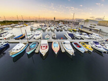 Looking Down Over Yachts And Boats In A Marina At Sunrise.
