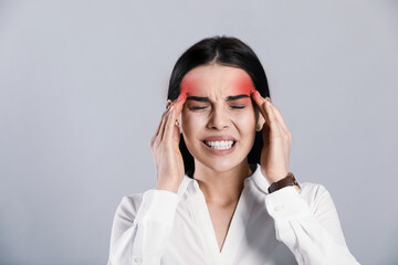 Wall Mural - Woman suffering from migraine on grey background