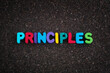 The word Principles on a dark cork board