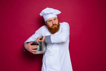 Wall Mural - chef with beard and red apron is jealous of his recipe