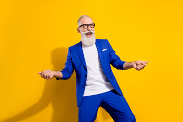 Wall Mural - Photo of funky grey beard senior man look empty space wear spectacles blue jacket isolated on vivid yellow color background