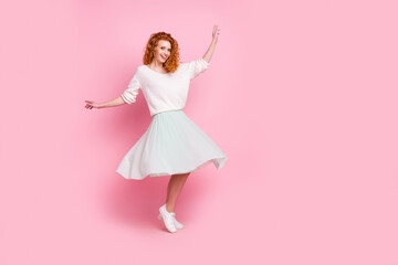 Full length body size photo of red hair girl in skirt dancing on holiday isolated on pastel pink color background