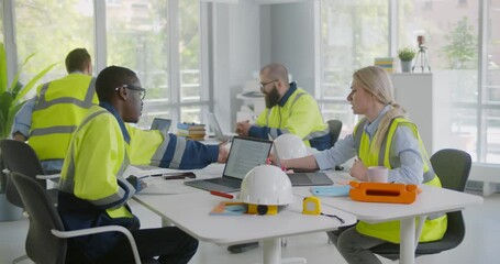 Wall Mural - Diverse engineers inspecting in workplace architectural plan