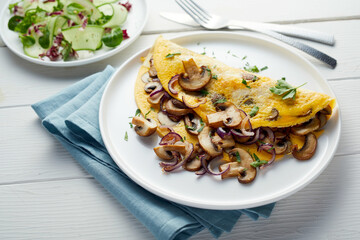 Appetizing vegetarian omelet and salad on table