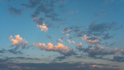 Wall Mural - dark and light clouds against a blue sky in the late afternoon.