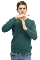 Young handsome tall slim white man with brown hair making letter t with his hands in dark green sweater isolated on white background