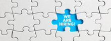 Blue Missing Puzzle Piece With The Word We Are Hiring. Employment Or Recruitment Announcement