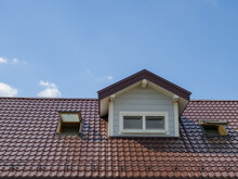 A Fragment Of A Metal-tile Roof With Two Dormer Windows.
