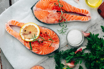 Fresh raw Salmon. fish fillet with herbs and lemon. healthy food, diet or cooking concept