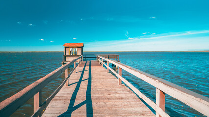 Wall Mural - Wooden Pier For Fishing, Small House Shed And Beautiful Lake Or River In Background. Picturesque Natural Landscape In Berezinsky, Biosphere Reserve, Belarus