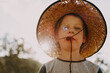 © Austockphoto - Young boy wearing a straw hat