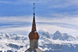 metal bell tower of a church in the shape of a bulb on a snowy mountain background