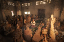 A Woman Praying In An Ancient Thailand Temple , At " Wat Samret" Koh Samui ,Suratthani	
