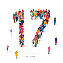 A large group of people is standing in colored clothes in the shape of the number 17. The concept of human numbers.