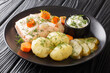 Swedish traditional cold poached salmon kall inkokt lax with new potatoes closeup in the plate on the table. horizontal
