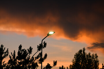 Public street lighting pole with LED lights with an amazing sunset color background.