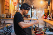 © ADDICTIVE STOCK - Man in bandana standing at counter and cooking ramen