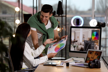 Poster - Professional retoucher with colleague at workplace in office