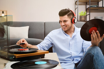 Wall Mural - Happy man listening to music with turntable at home