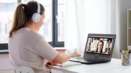 Canvas Print - education, online school and distant learning concept - student woman in headphones with laptop computer having video conference at home