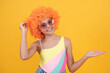 © Olena - april fools day. happy childhood. birthday party. funny kid in curly clown wig. having fun.