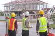 © saravut - Construction engineers supervising progress of construction project