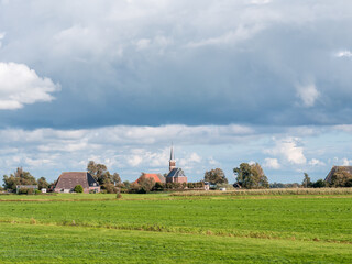 Wall Mural - Polder with grassland, farmhouse and church of Cornjum, Friesland, Netherlands