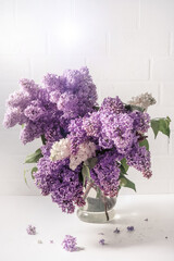 Poster - A bouquet of lilac on a light background. Shabby chic style. Soft focus.