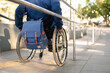 © Vergani Fotografia - person in wheelchair with blue backpack arriving destination.