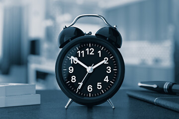 Poster - black luxury classic analog alarm clock on a table in blue key. 3d rendering