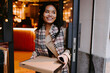 © ADDICTIVE STOCK - Asian woman picking up take out food in a restaurant