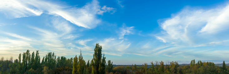 Wall Mural - Landscape with dramatic light - beautiful golden sunset with saturated sky and clouds.