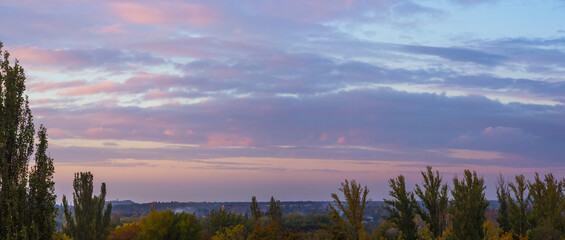 Wall Mural - Landscape with dramatic light - beautiful golden sunset with saturated sky and clouds.