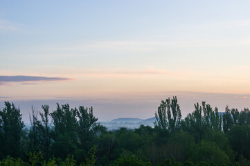 Wall Mural - Landscape with dramatic light - beautiful golden sunset with saturated sky and clouds.
