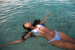 © ADDICTIVE STOCK - Model in swimsuit resting in pure ocean