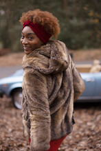 Portrait Happy Young Woman In Fur Coat In Autumn Park