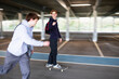 © Sam Edwards/Caia Image - Teenage boys skateboarding in car park