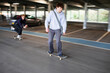 © Sam Edwards/Caia Image - Teenage boys skateboarding in car park