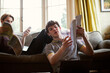 © Sam Edwards/Caia Image - Teenage boys with textbooks studying on sofa at home