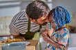 © Trevor Adeline/Caia Image - Affectionate father and cute toddler daughter in kitchen