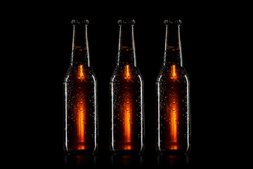 Wall Mural - Small brown beer bottle with drops on black background
