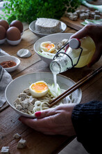 Anonymous Person Preparing Ramen Soup With Chopsticks