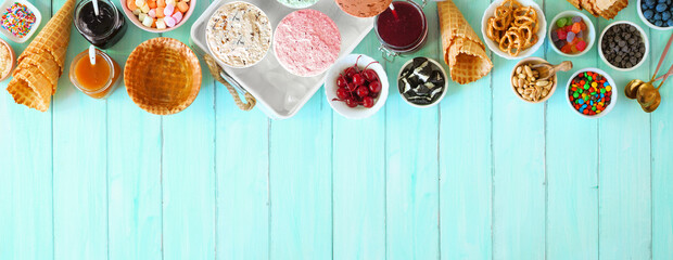 Poster - Summer ice cream buffet with assorted of flavors and sweet toppings. Above view table scene on a blue wood background.