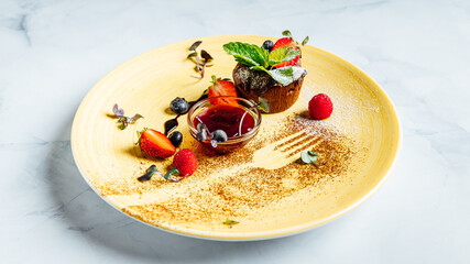 Sticker - Closeup of a chocolate muffin with a  bowl of strawberry jam on the plate