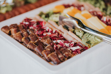 Wall Mural - Closeup shot of a set of salami and cheese on a buffet table