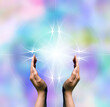 © Visualmind - hands and bright light, power of Reiki concept