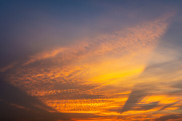 Wall Mural - beautiful vivid sky painted by the sun leaving bright golden shades.dense clouds in twilight sky in 