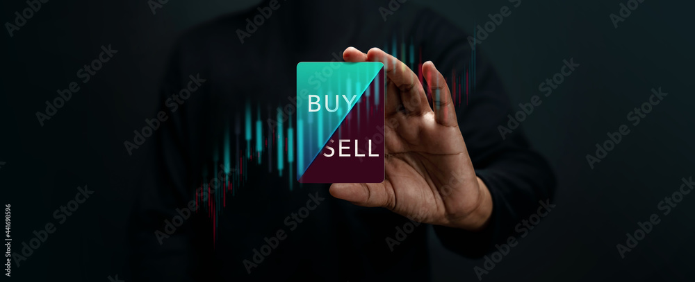 Stock Market Share Investment Strategy Concept. Investor Holding a Card to Decision for Selling or Buying. Take or Lose Profit. surrounded by Stock Marketing Graph. Dark tone