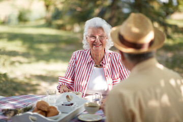 caucasian elderly couple enjoy outdoor, having breakfast and coffee